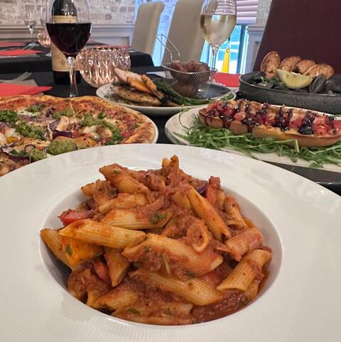 A full table of Italian dishes at Don Michele